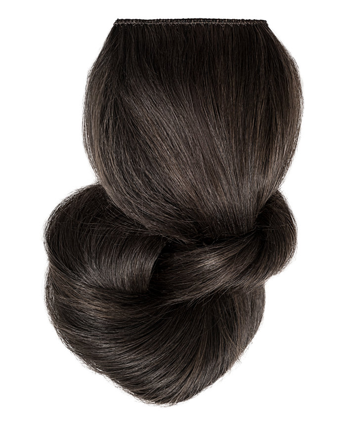 Clip In Extensions | A studio image of a loosely braided black clip on extension.