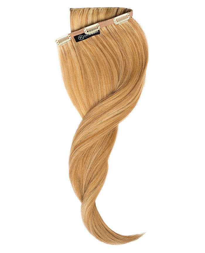 Clip In Extensions | A studio image of a slightly twisted honey blonde clip on extension.