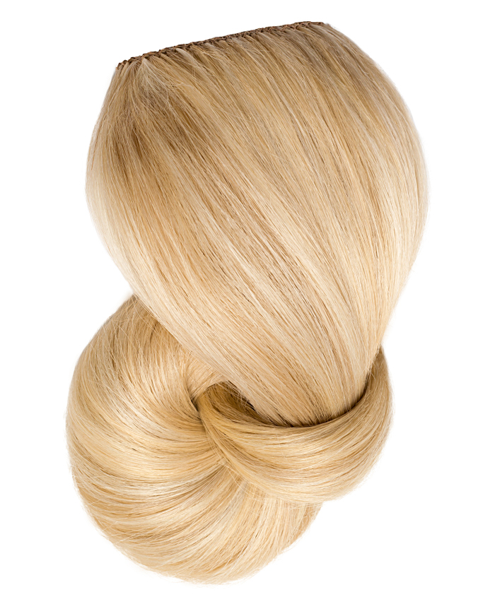 Clip In Extensions | A studio image of a loosely braided platinum blonde clip-on extension.